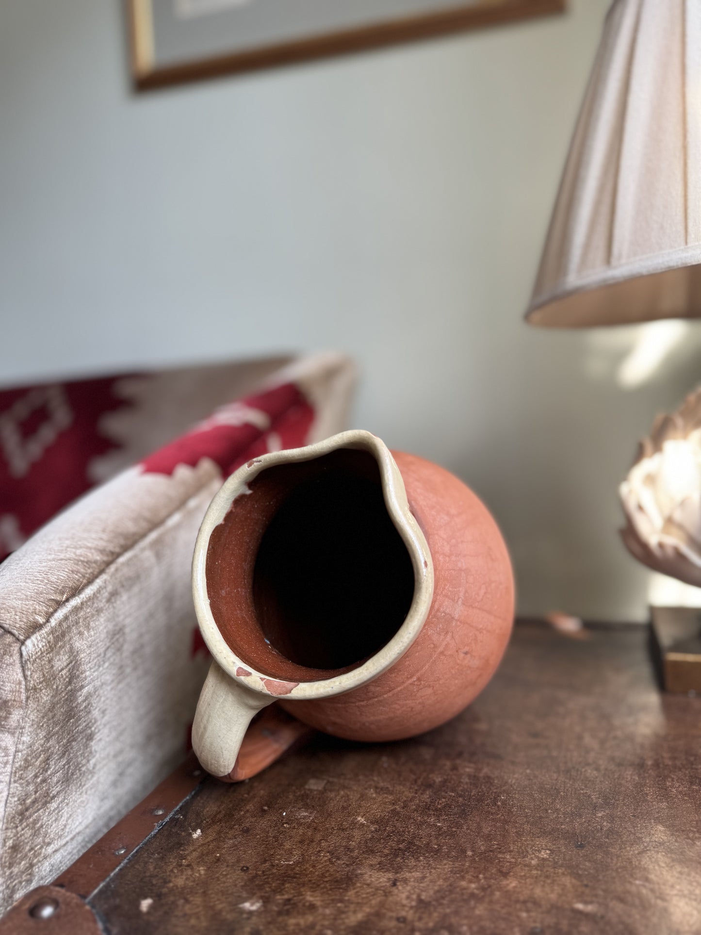 Terracotta jug with white rim